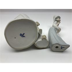 Three Lladro figures, comprising Bird no 1054, Shepherdess with rooster no 4677 and Boy with Dog no 4522, together with a Nao figure 