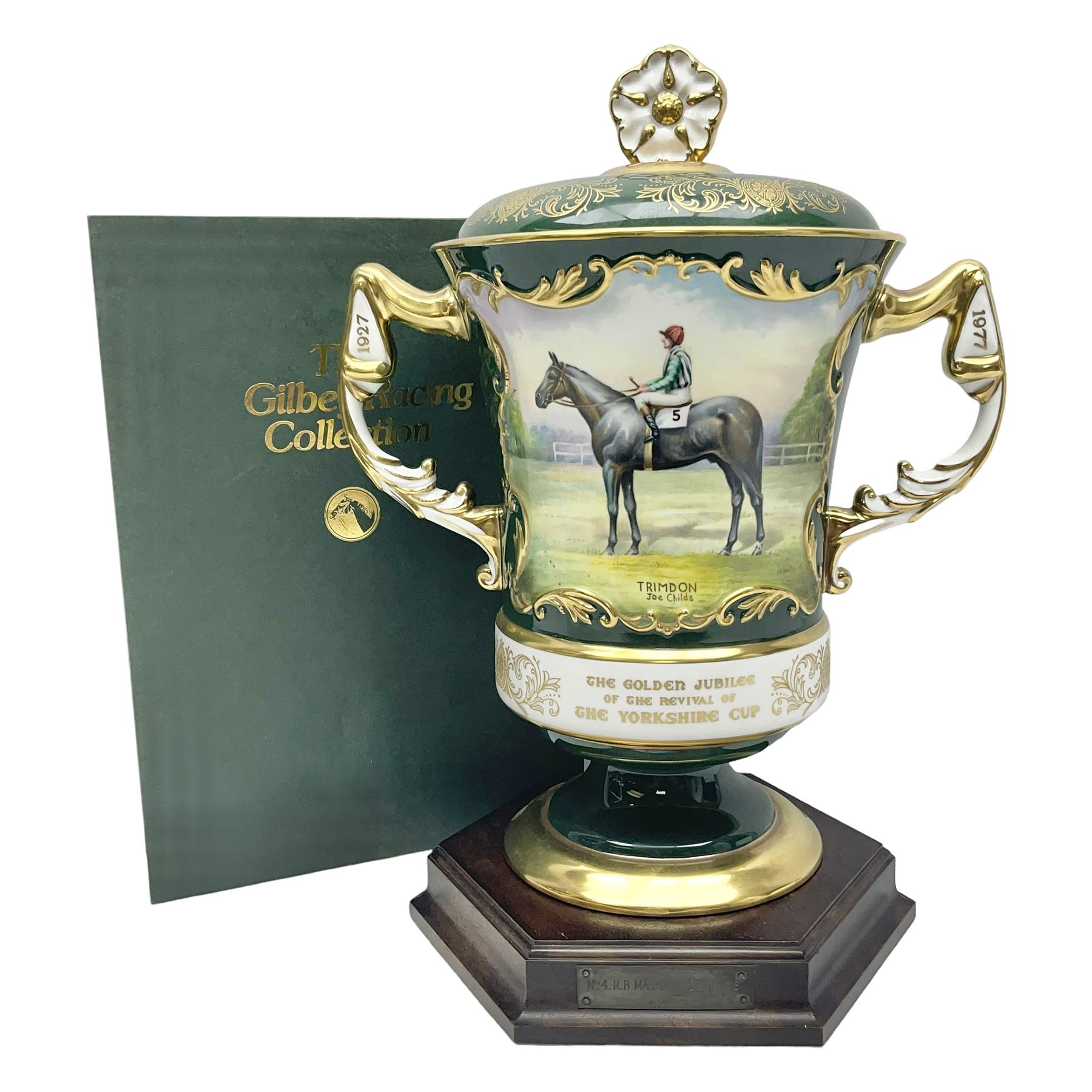 Aynsley twin handled racing cup and cover, to commemorate 'The Golden Jubilee of the Revival of The Yorkshire Cup', the handles inscribed '1927' and '1977', the green body painted by E. Woodhouse with Joe Childs up on Trimdon, the reverse with the winners, the domed cover with a Yorkshire rose finial, limited edition no. 4 of 50, on hexagonal wooden base with certificate, H34cm