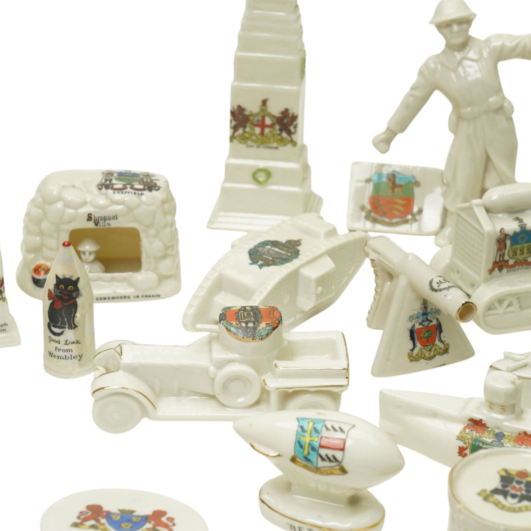 WW1 crested china including Grafton 'The Bomb thrower', Swan 'Nurse & Wounded Tommy', Model of Motor Tractor used on Western Front', two tanks, ambulance, Cenotaph etc