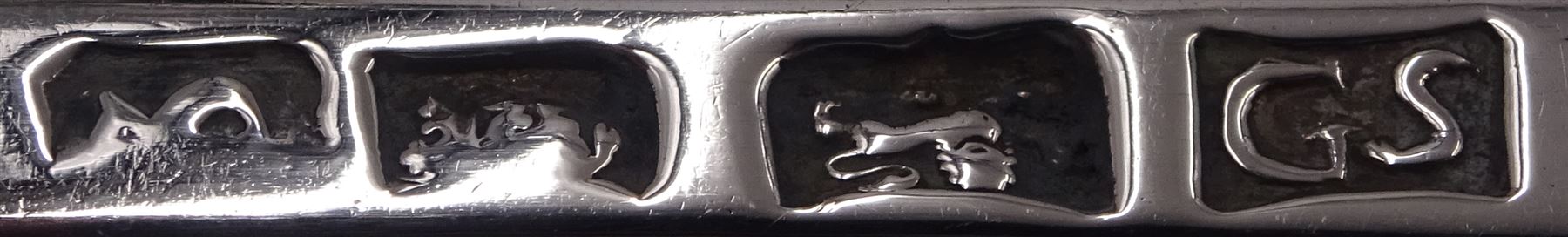 Set of three George III silver Old English pattern table spoons, each engraved with monogram to terminal and with dart border to handle, hallmarked London circa 1770, maker's mark GS, hallmarks worn and partially indisitinct