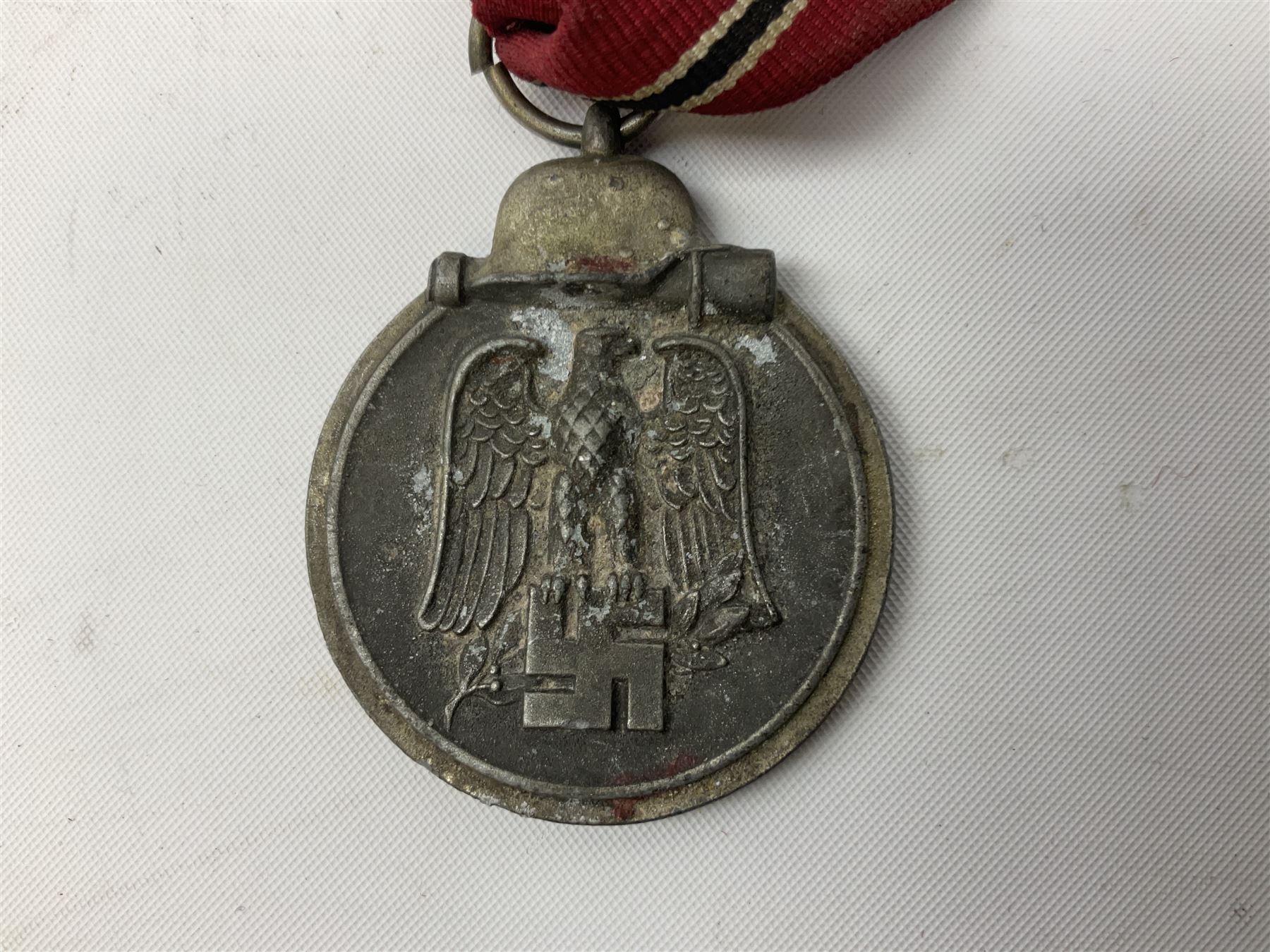 WW2 German Eastern Front Medal awarded to those who served on the German Eastern/Russian Front during the Winter Campaign period of 15th November 1941 to 15th April 1942 with original ribbon; and German War Merit Cross with swords 2nd Class (2)