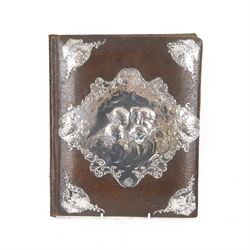 Edwardian silver mounted stationery box and silver mounted blotter, the box of rectangular form with curved front with applied repousse silver panels of putti within a scrolling foliate edge, the hinged cover opening to reveal an emerald green silk lined interior, the blotter with conforming silver mounted panels, each hallmarked William Comyns & Sons, London 1901, box H20cm W31cm D14cm, blotter H32cm W26.5cm