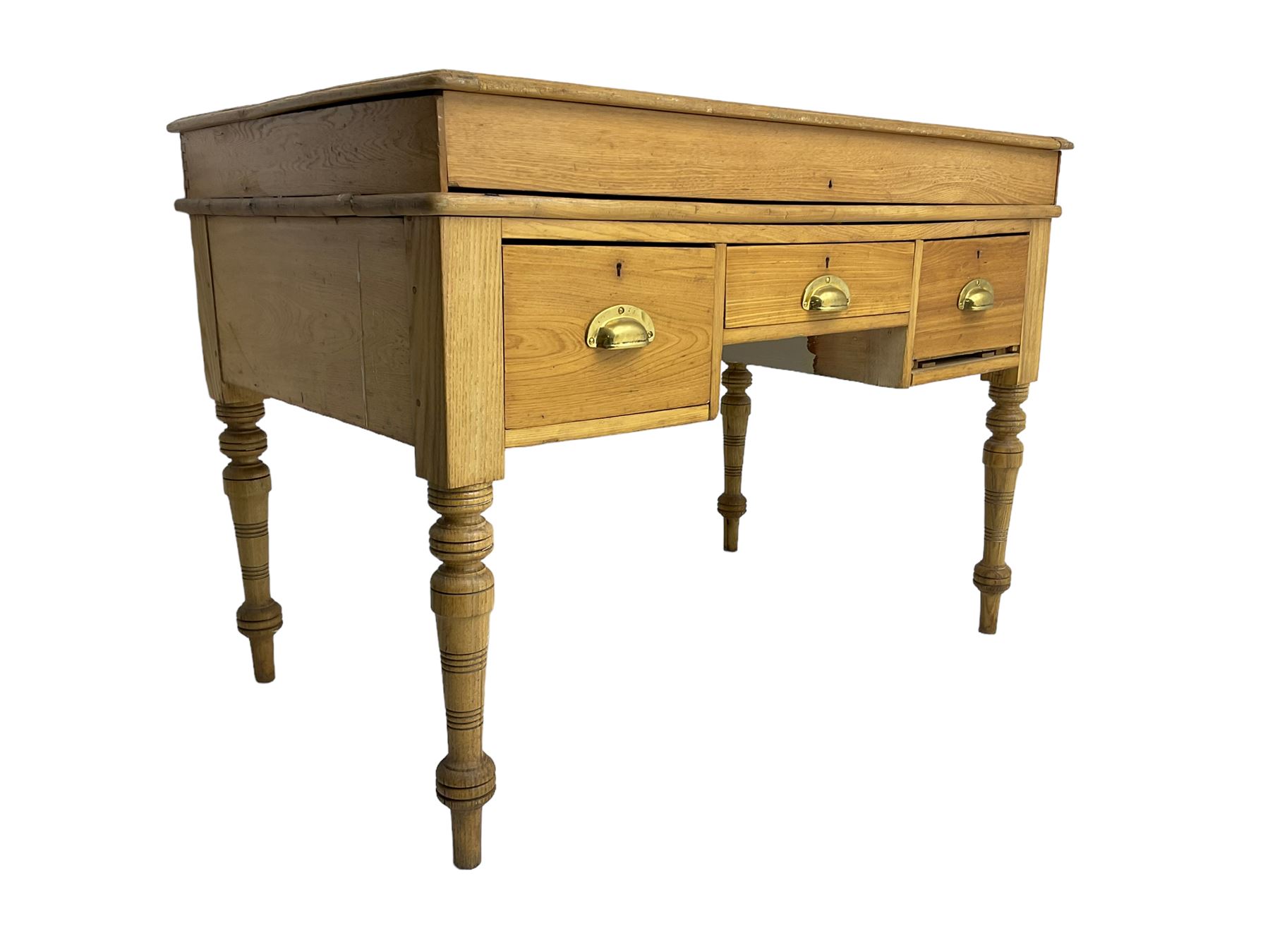 Early 20th century light oak kneehole desk, rectangular hinged top, fitted with frieze drawer flanked by two deep drawers, raised on ring turned supports