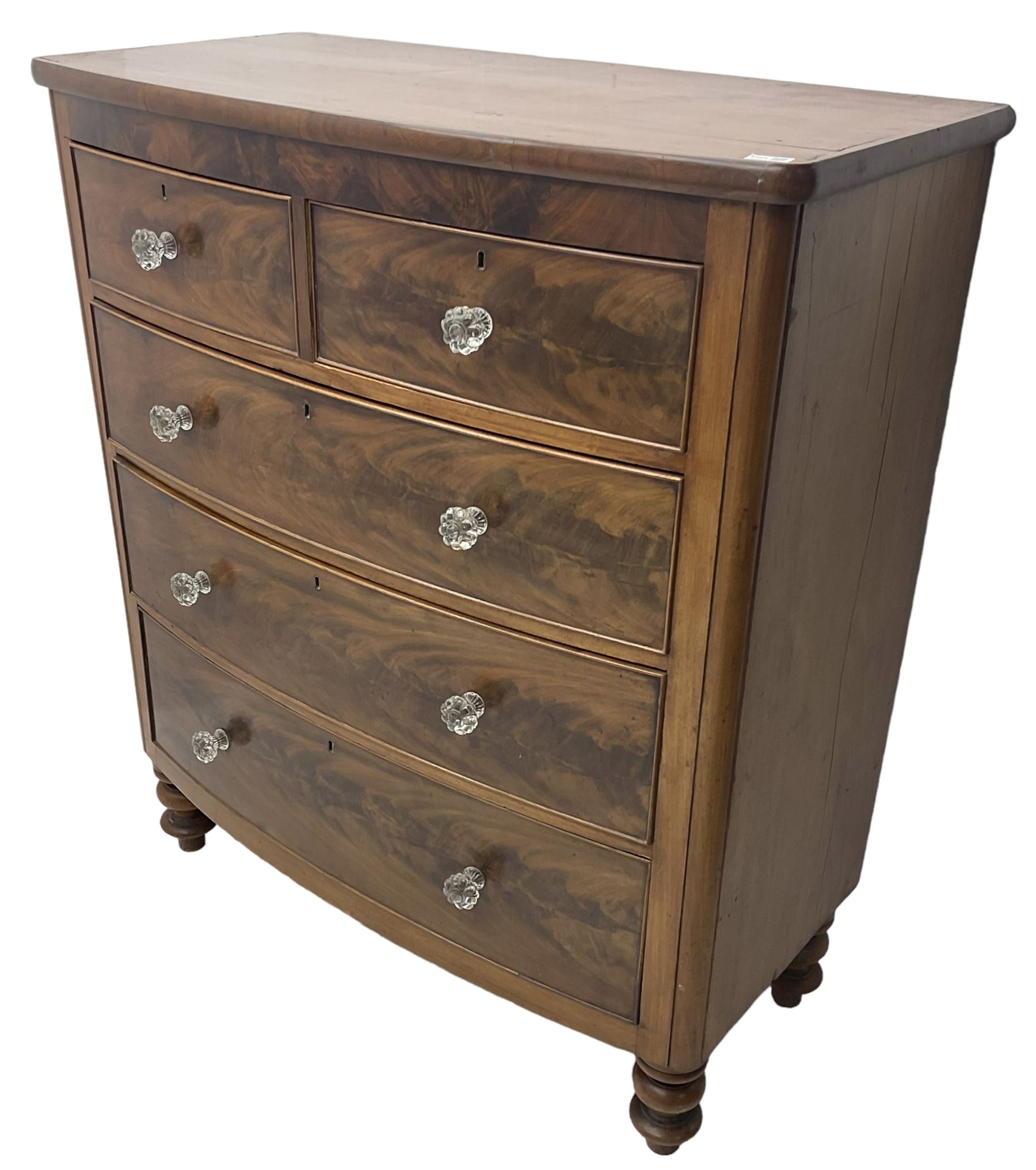 Victorian mahogany bow front chest, fitted with two short over three long graduating cock-beaded drawers, each with glass handles, raised on turned feet