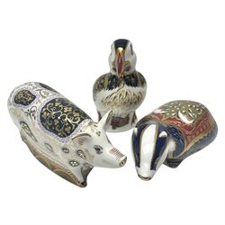 Three Royal Crown Derby paperweights, comprising Moonlight Badger, Puffin and Spotty Pig, all with gold stopper, printed mark beneath and original box