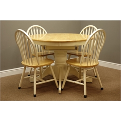  Lightwood circular extending dining table with fold out leaf, on painted turned pedestal with splay legs (D107cm - 152cm, H78cm), and four stick and hoop back chairs to match  