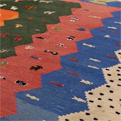 South West Persian Qahgai pictorial flatweave kilim, design arranged in a series of irregular vertical bands in shades of indigo, blue, madder red, pink, green, and ivory, each band filled with naïve pictorial and symbolic motifs of stylized human figures, sheep, goats, and birds