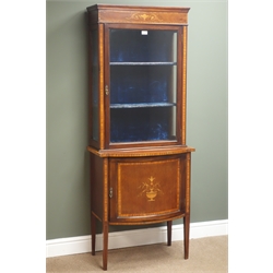  Edwardian inlaid mahogany display cabinet, projecting cornice, frieze with urn and foliate marquetry, glazed door enclosing two shelves, above bow fronted cupboard, square tapering supports, W67cm, H171cm, D42cm  