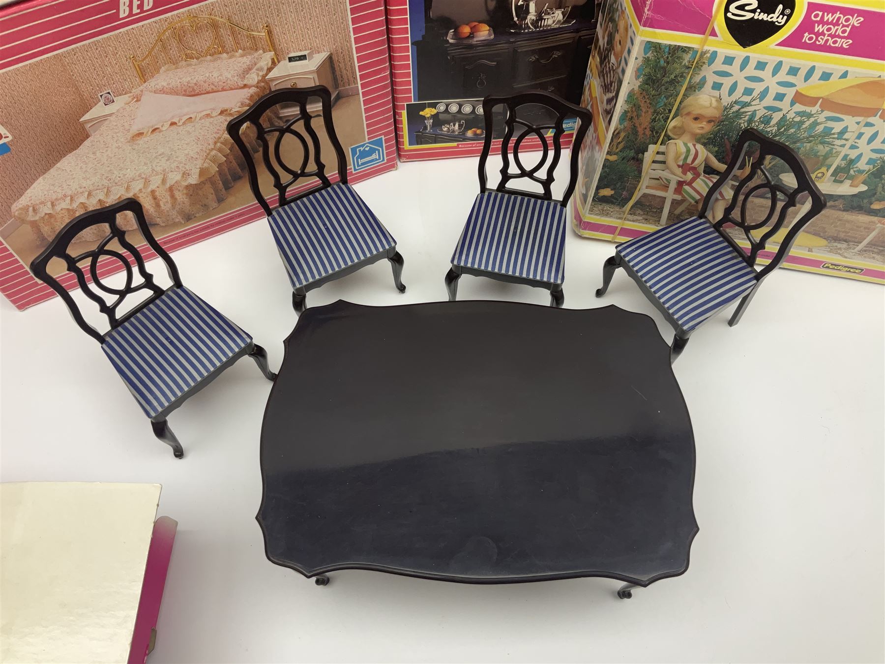 Sindy - furniture and accessories comprising dining suite with separate dresser; two beds; Garden Set; Music Centre; all  boxed; three-piece bedroom suite; settee; Hostess Trolley; two coffee tables; and four-piece bathroom suite including shower cubicle