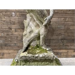Life-size weathered cast stone Greek Discus Athlete, seated on rectangular slab raised on associated architectural plinth
