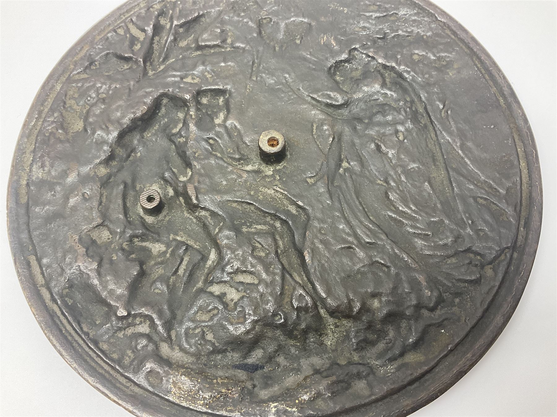 Late 19th century bronze plaque, of circular form, depicting the angel appearing to Adam and Eve in the garden of Eden in high relief, D25.5cm
