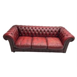 Mid-20th century chesterfield three seat sofa, upholstered in oxblood buttoned leather, the scrolled arms with studwork