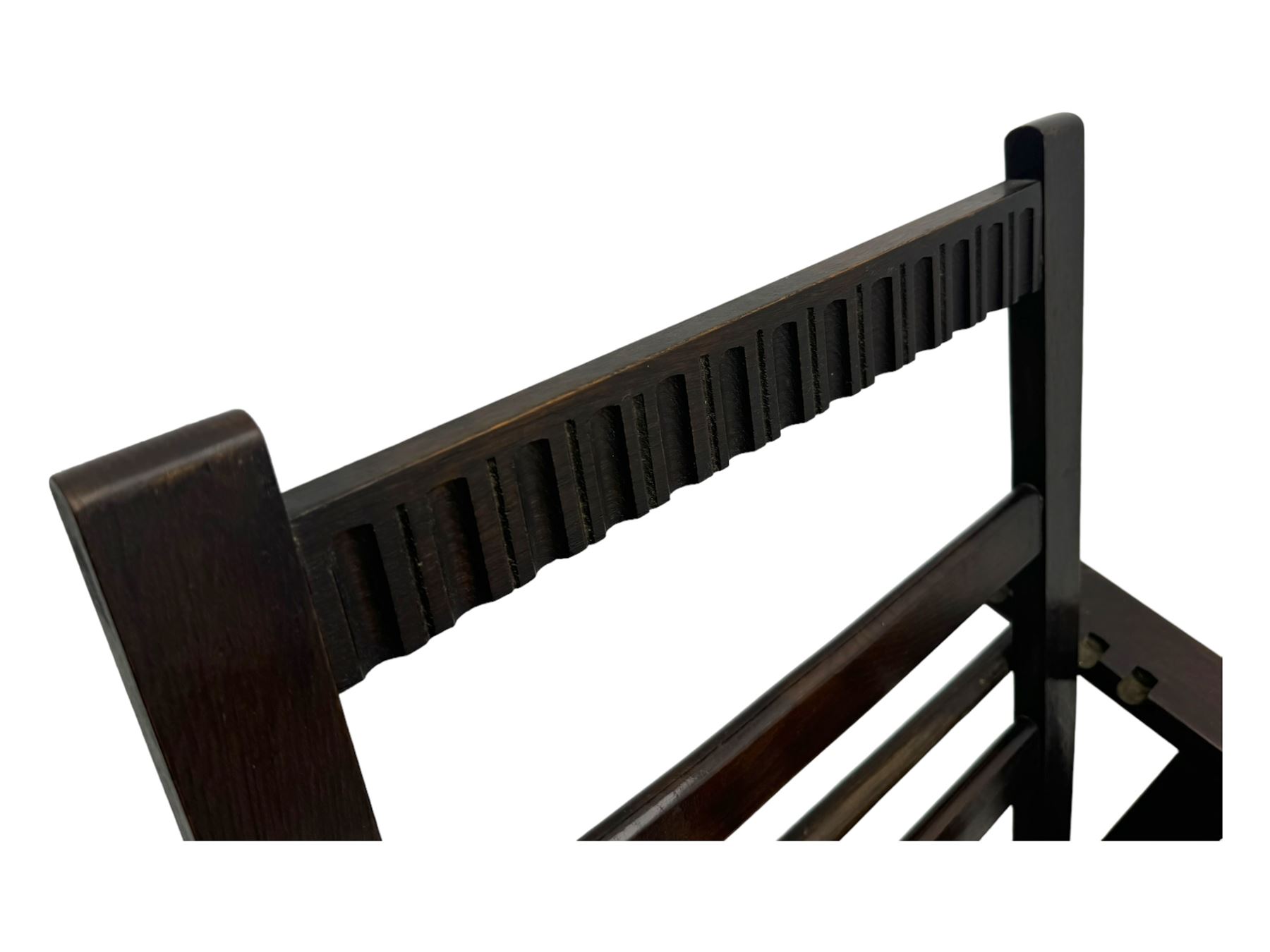 Late Victorian oak steamer chair, adjustable slatted backrest with grooved crest rail, wide armrests extending to a sliding adjustable footrest, open frame sides with vertical slats, side magazine rack and collapsible table, raised on turned front supports