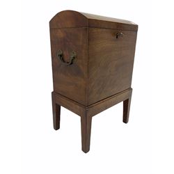 George III mahogany cellarette, rectangular form with hinged dome lid, fitted with two brass carrying handles, on base with square tapering supports