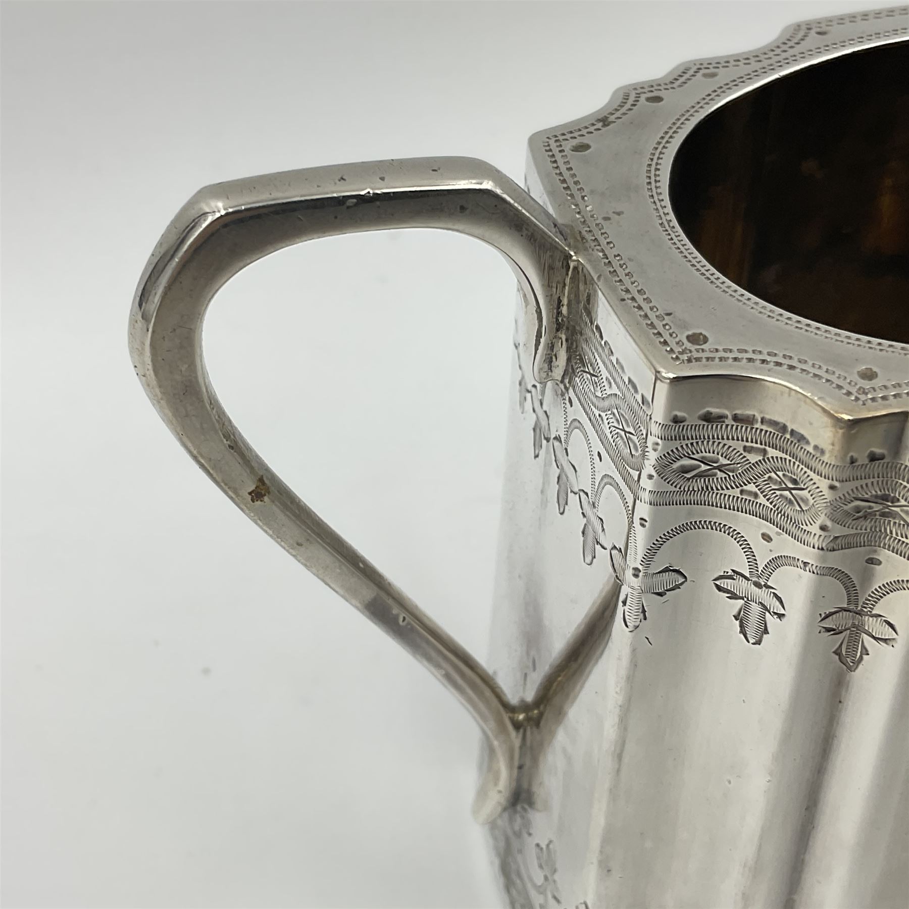 Victorian three-piece silver tea service, comprising teapot, twin handled open sucrier and milk jug, of oval form with shaped rim and C handles, each engraved with crests and bands of strapwork decoration, the milk jug and sucrier with gilt interiors, hallmarked Josiah Williams & Co, Exeter 1881, the teapot with ivory insulators and finial, all contained with a tooled leather, blue silk and velvet lined fitted case, retailed by West & Sun, Dublin 
This item has been registered for sale under Section 10 of the APHA Ivory Act