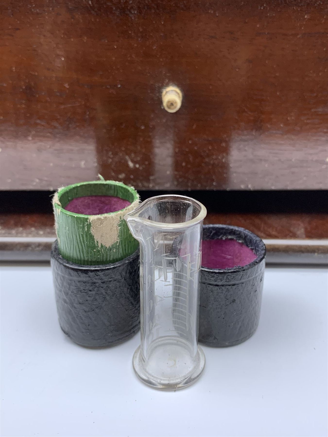 19th century mahogany travelling apothecary cabinet, with recessed brass carry handle to top, and two deep-section hinged doors to the front opening to reveal a fitted interior with clear glass bottles and two drawers, H27cm