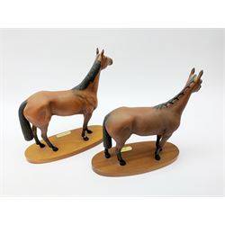 Four Royal Doulton horse figurines, comprising Red Rum, Arkle, and the Winner DA154, and another modelled as a prancing bay horse, largest H32cm. (4). 