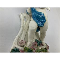 Victorian wall pocket by Moore Brothers retailed by T.Goode modelled as a semi nude white glaze cherub with turquoise ribbon, with encrusted floral decoration, the reverse stamped ‘T.Goode & Co.’, H32cm