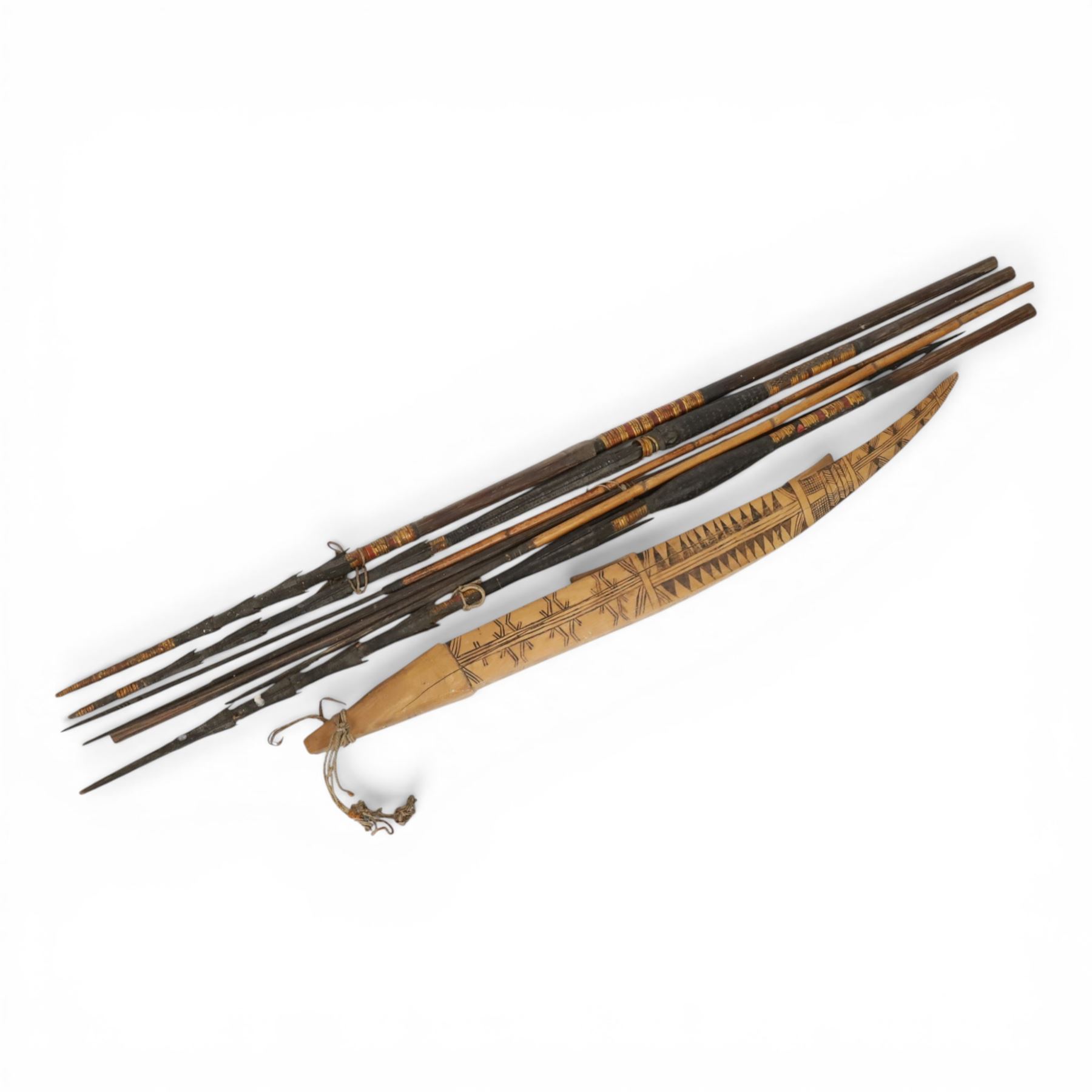 Papua New Guinea tribal fishing spears, together with carved boat 