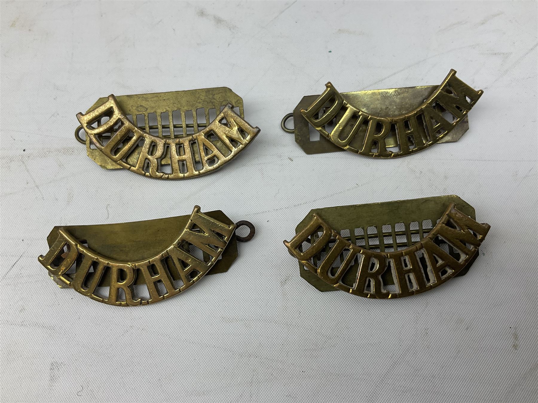 WW1 pair of medals comprising British War Medal and Victory Medal awarded to 24085 Sjt. J. Hazle Durh. L.I.; together with Durham Light Infantry cap and collar badges, shoulder titles, buttons etc; various royalty commemorative medallions etc