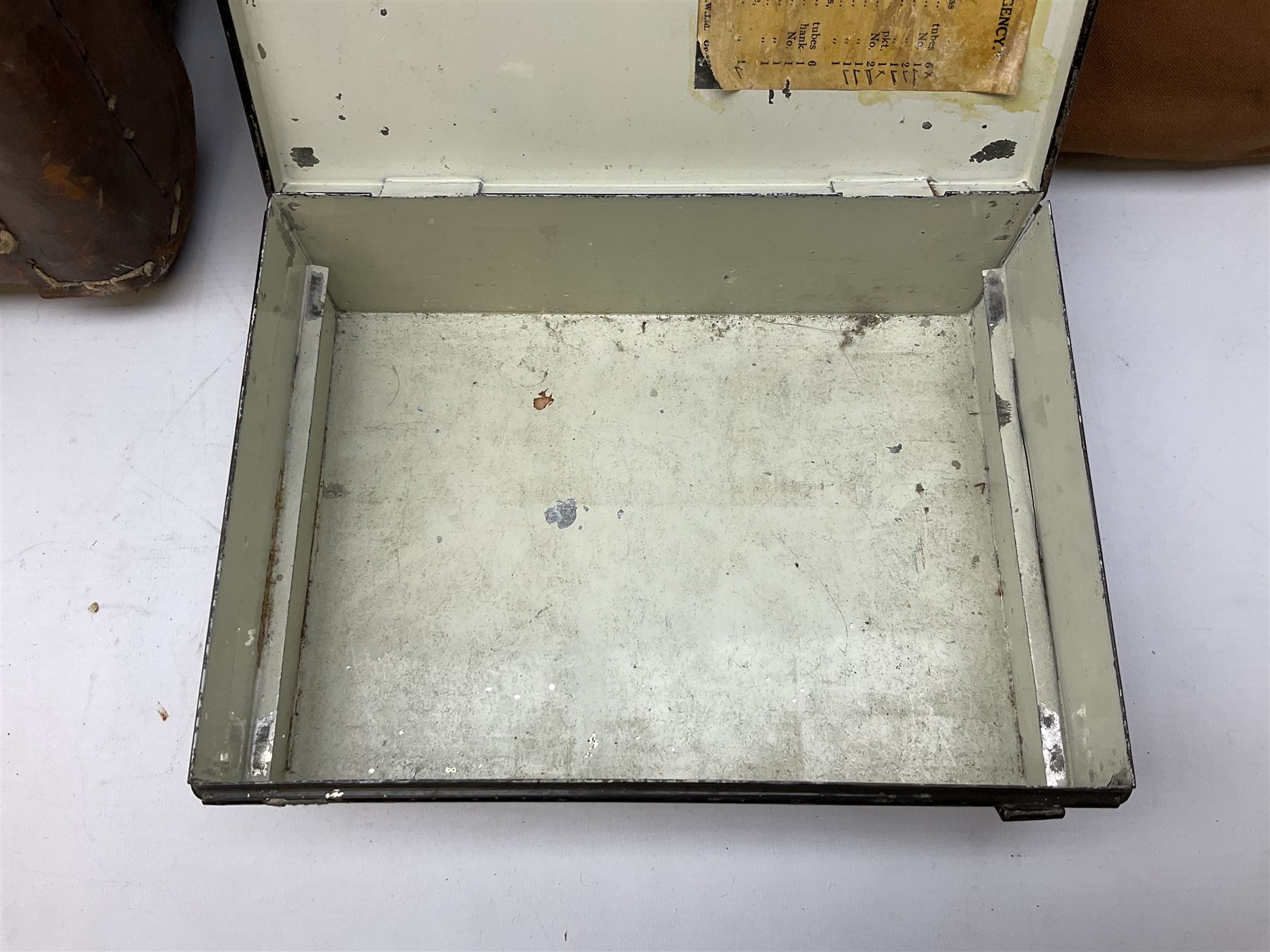 WW2 British Army RAMC 'Regimental Medical Pannier', well marked externally and dated 1941, stamped May 1943 internally, canvas covered wicker form with leather edges, hinged top and fall front with two rope carrying handles, fitted iron locking straps with securing chains; contains various unused field dressings and bandages with WW2 dates and two pillows; original label under lid L79cm