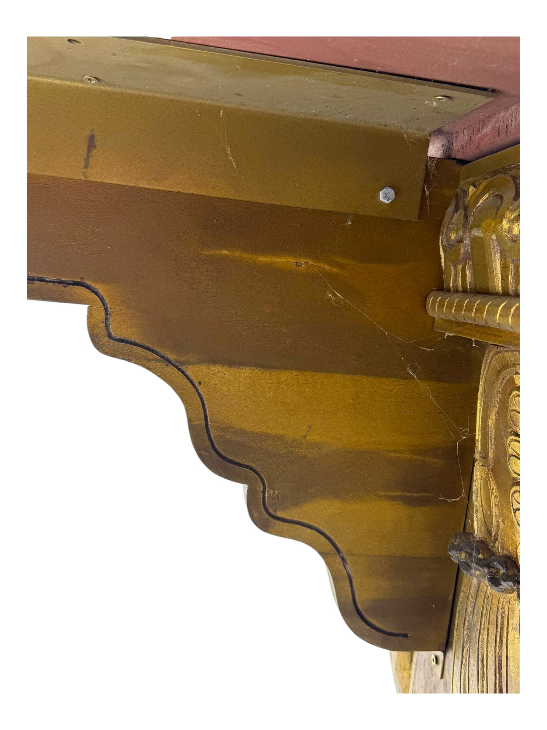 19th century Renaissance Revival carved and giltwood centre table, the rectangular top with gadrooned edge and carved frieze of repeating arched motifs with stylised scrolls, supported by a pair of carved winged griffin supports restrained by a central chained figure, on stepped rectangular bases united by carved stretcher