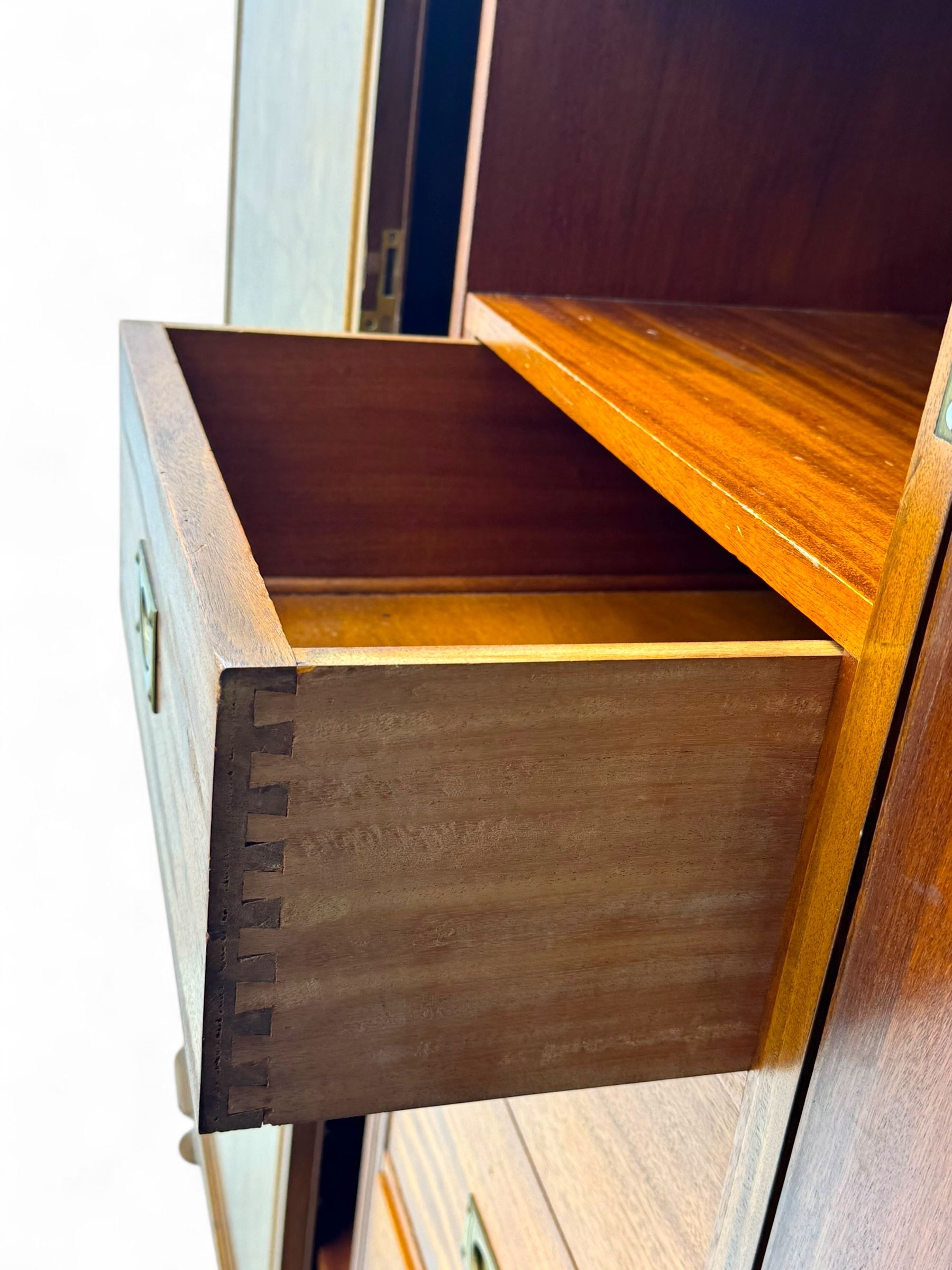 Ashton Leach & Cumberbirch Ltd., Rochdale - early 20th century walnut and mahogany gentleman's wardrobe, arched moulded top with book-matched figured walnut veneers, double doors enclosing fitted interior with hanging rail, tie rack and drawers, raised on cabriole supports