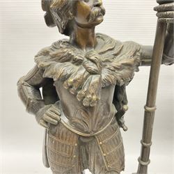 Pair of bronzed figure modelled as a hunter in traditional dress, each holding a pike, H48cm