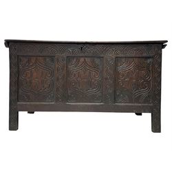 English carved oak coffer, hinged rectangular lid with indented side edges, internal candle-box, front with three-panel front with decorative carvings, raised on stile feet, circa 1700