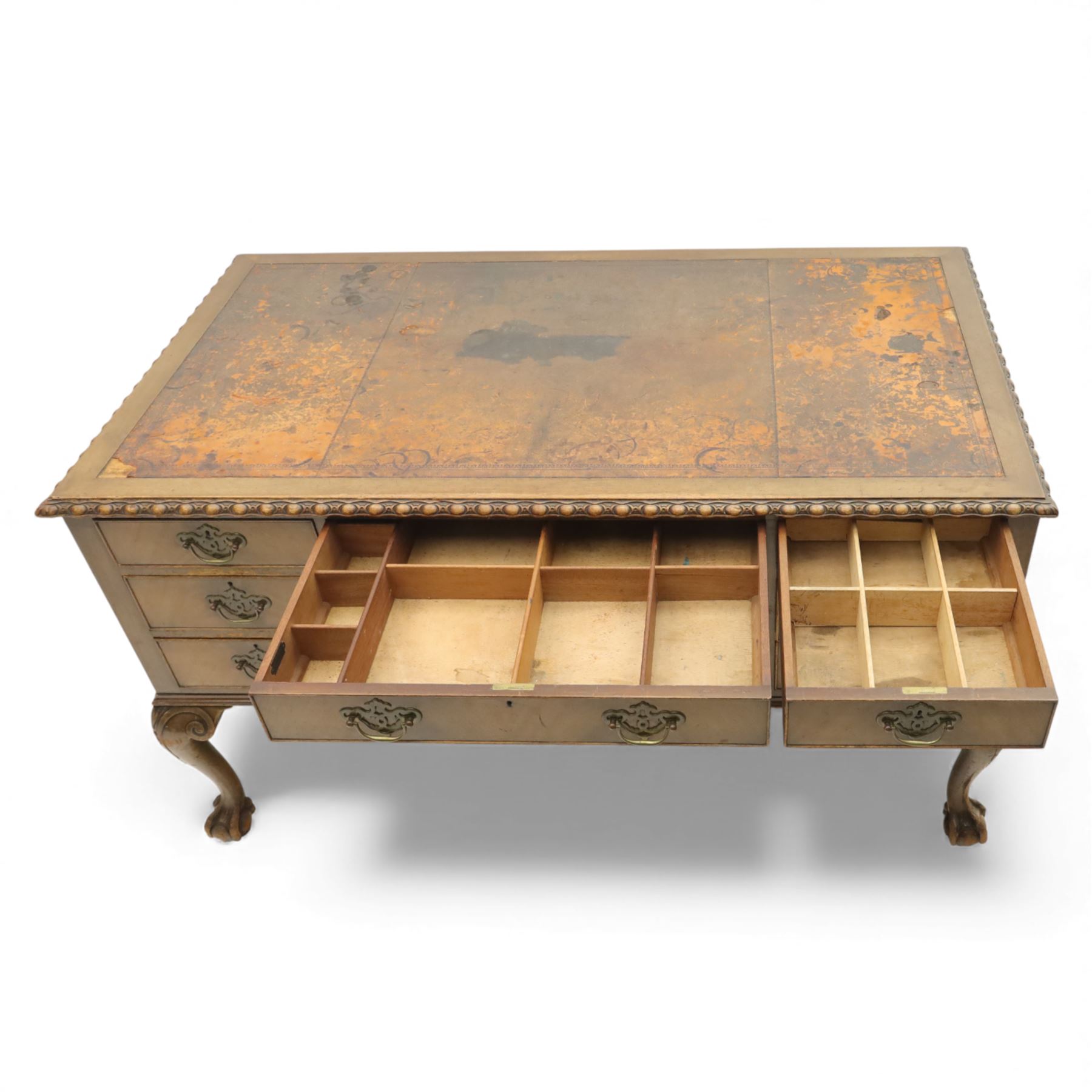 Waring & Gillow - Early 20th century mahogany desk, the leather-inset top above a shaped kneehole, central compartmented frieze drawer flanked by twin banks of of three drawers, each with brass handles, raised on cabriole legs with carved ball and claw feet (Height from floor to underside 62cm)