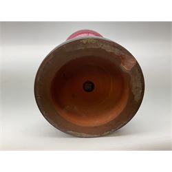 Victorian table standing oil lamp, brass fittings, cranberry glass reservoir, brass column on black enamelled ceramic base, with a frosted glass shade and clear glass chimney, H68cm