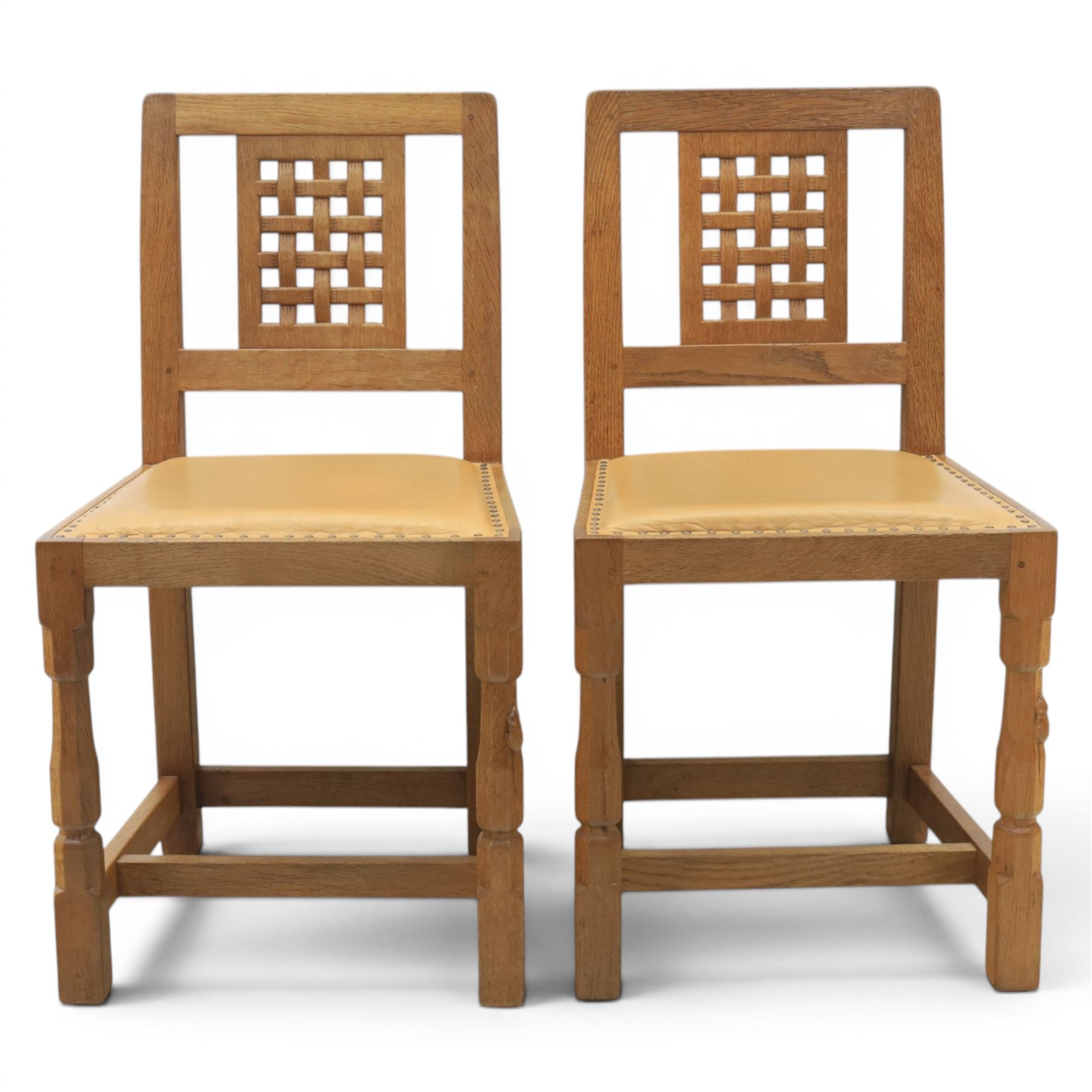 Mouseman - set of four oak lattice back chairs with tan seat with brass studded trim, with carved mouse signature, by the workshop of Robert Thompson of Kilburn