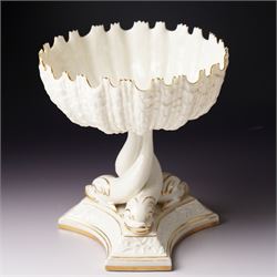 19th century Royal Worcester comport, painted with gilt on a cream ground, the stem formed as three entwined dolphins raising the shell shaped bowl, faint mark to base, H19.5cm