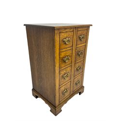 Titchmarsh & Goodwin - oak cabinet, enclosed by two doors with false drawers, on bracket feet