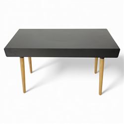Modern black single drawer desk, black rectangular top above a single oak veneered drawer with black metal pull, flanked by two open shelves raised on tapering oak veneer legs (From floor to underside 64cm)