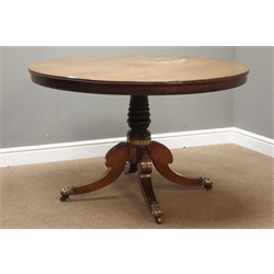  Regency rosewood breakfast table, circular tilt top with herringbone stringing, turned column with four splayed supports, brass claw castors, D115cm, H72cm  