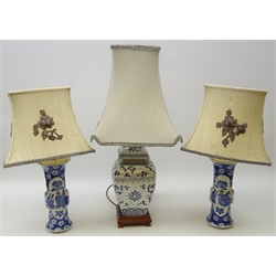  Pair of 20th century Chinese blue and white table lamps painted with panels of precious objects on Cherry Blossom decorated ground with Applique shades and square section Chinese blue and white vase with shade on hardwood stand (H65cm including shade)  