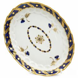 18th century Worcester teapot and stand of oval wrythen form decorated with flowers and leaves in blue and gilt, with blue crescent mark