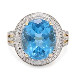 14ct gold Swiss blue topaz and diamond cluster ring, single oval cut topaz of approx 8.85 ...