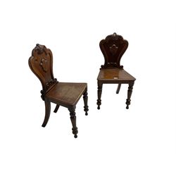 Pair of Victorian mahogany hall chairs, shaped moulded back carved with cartouche, moulded seat on turned front supports