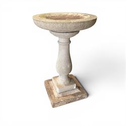 Weathered cast stone statue of a child and urn planter on pedestal along with three piece bird bath