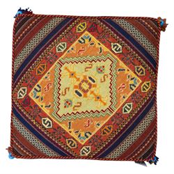 South West Persian Qashqai stool, square flatwoven top with central geometric medallion enclosed within a stepped border the sides decorated with striped bands of geometric motifs with tasselled corners 