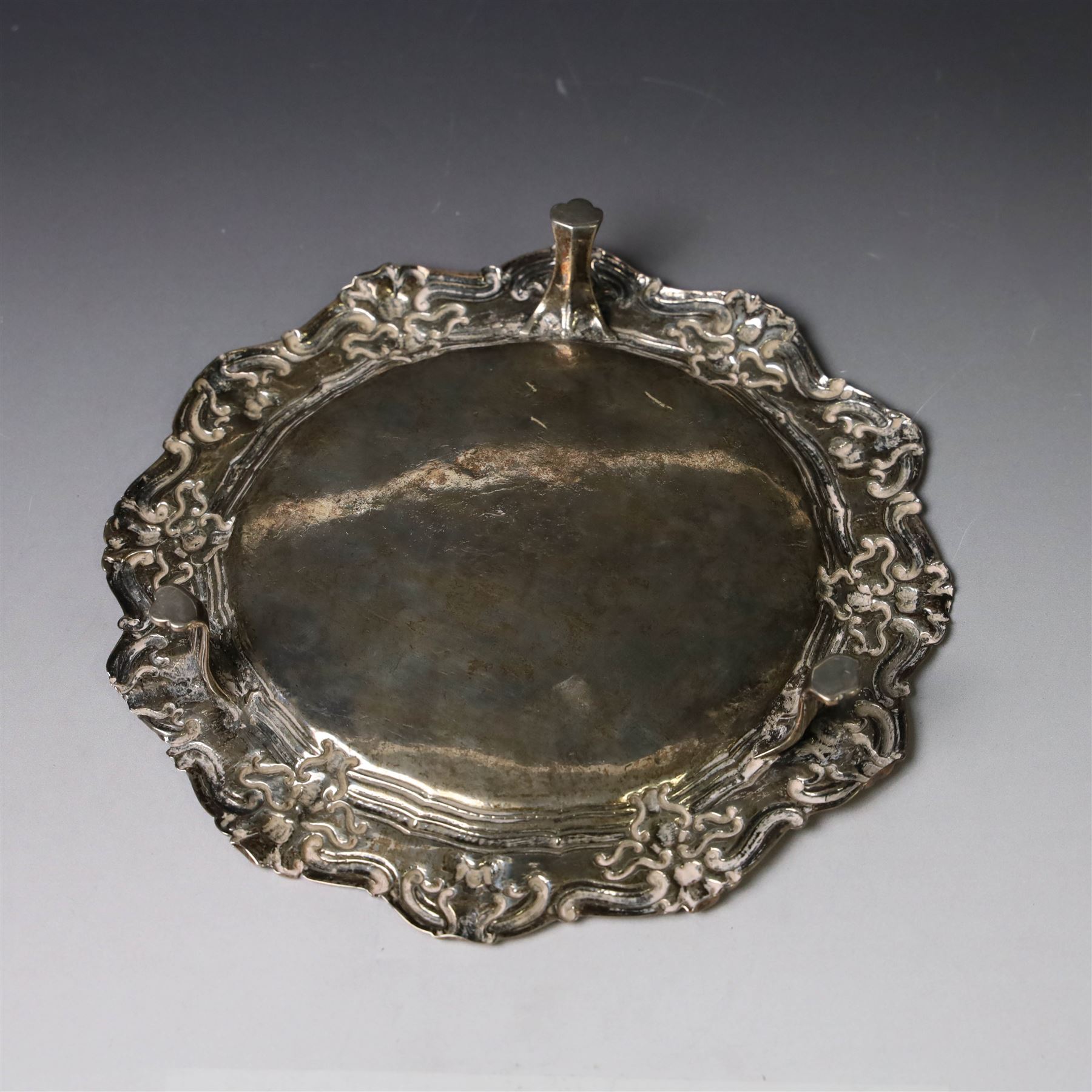 19th century continental silver waiter, of hexagonal form with stipple and scroll border, engraved with floral decoration to centre, upon three stylised paw feet, W19.2cm