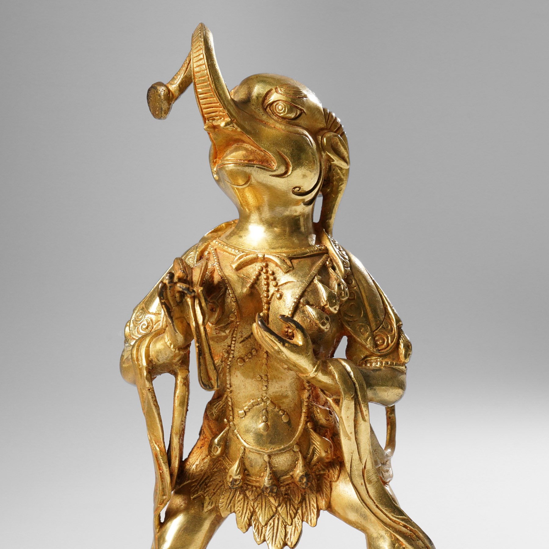 Tibetan gilt bronze figure of Ekadashamukha Avalokiteshvara, standing upright on lotus base, his primary hands in anjali mudra, the other six radiating to the sides, H28cm; together with a gilt bronze figure of Ganesh or Ganapati, H26cm (2)