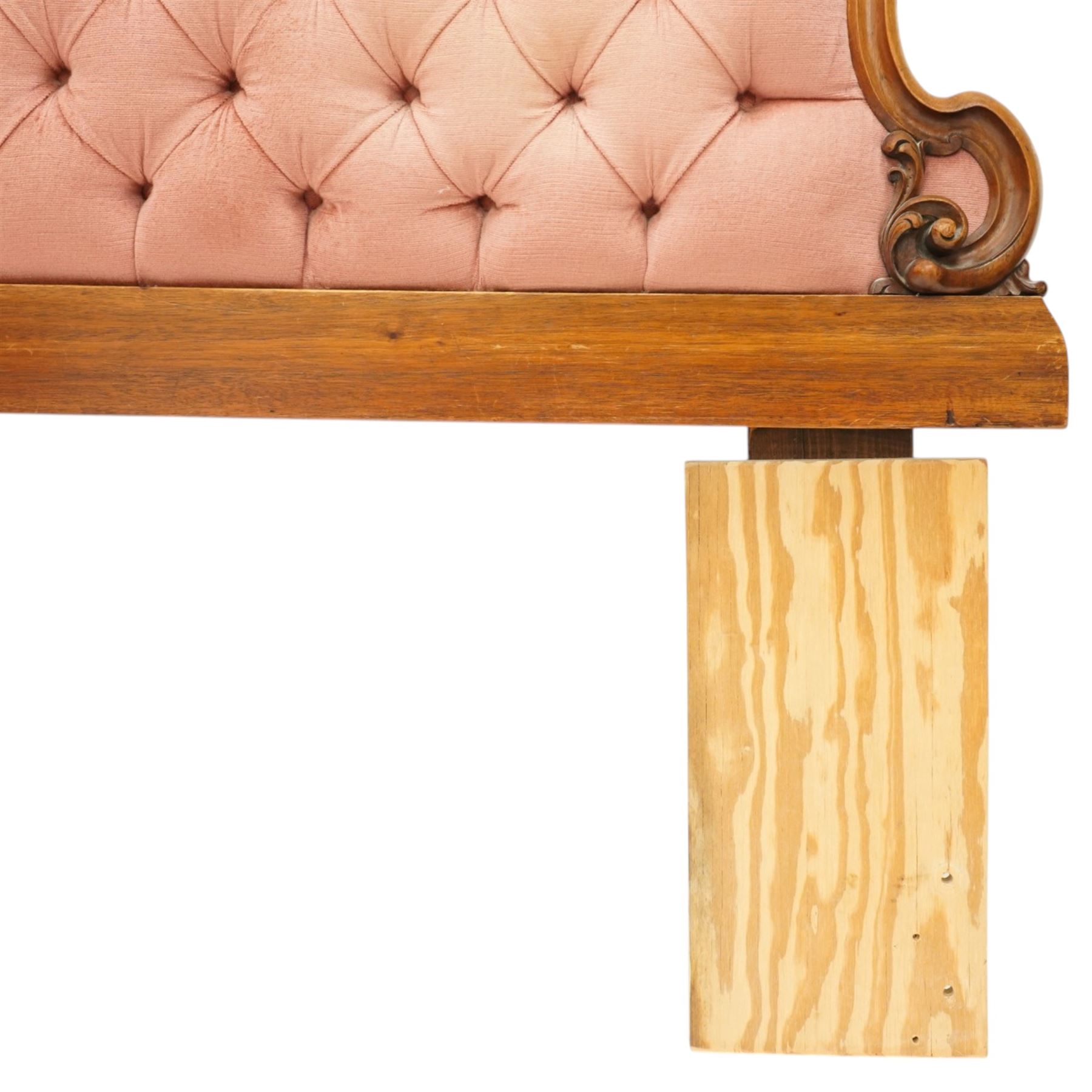 Two 20th century headboards, one with scrolled rail above a pink button backed board (H c127m, W 137cm) the second with flamed mahogany veneer (H 117cm, W 163cm)