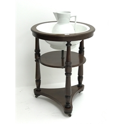  Early 19th century circular mahogany two tier washstand with ceramic bowl and jug, three turned supports, on brass and ceramic castors, D61cm, H80cm  