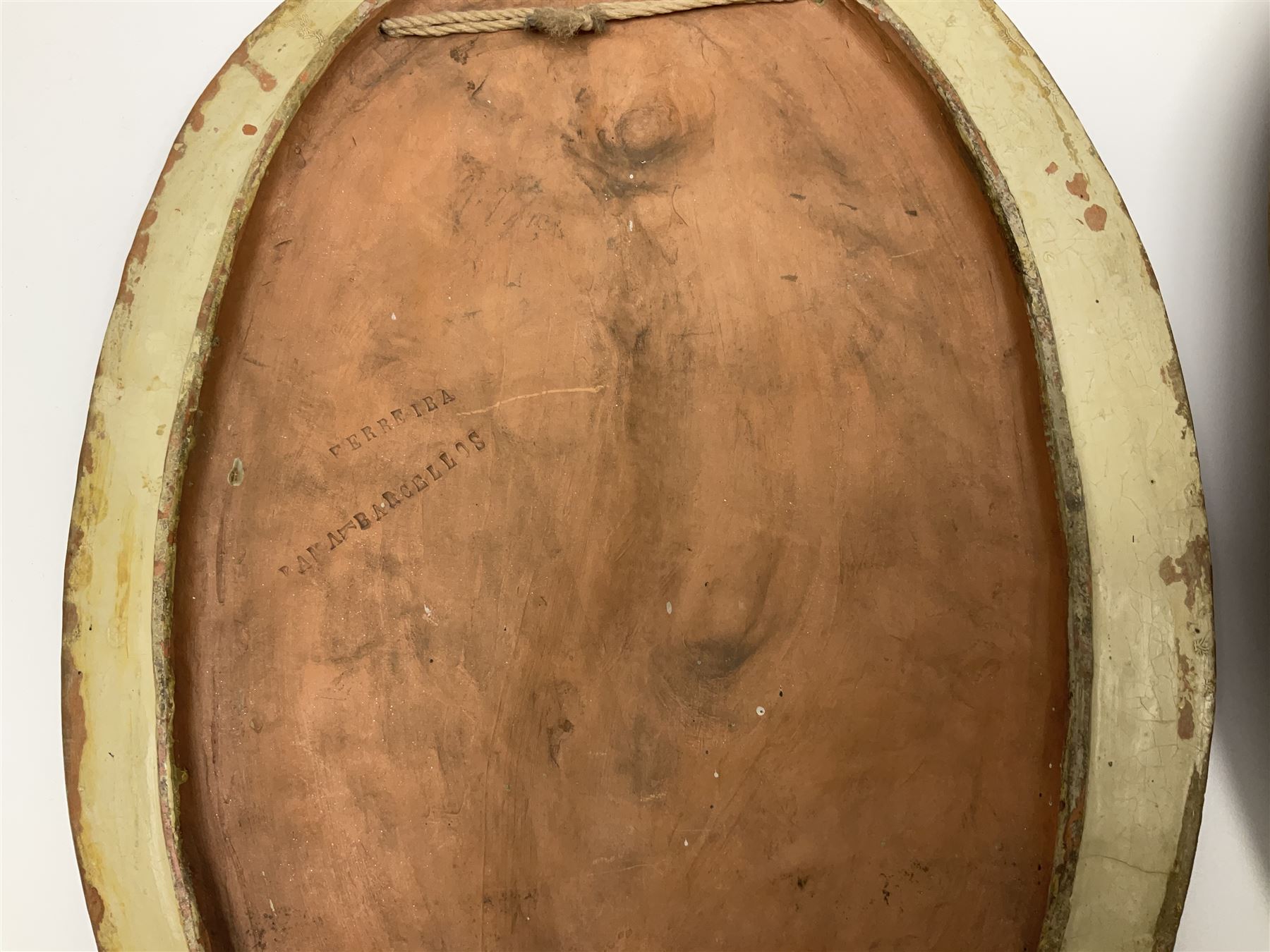 Pair of 19th century classical terracotta relief wall plaques depicting the goddess Hygeia and another goddess, seated holding an ewer, each of oval form, indistinctly signed, each stamped Ferreira verso, H42cm, W30cm