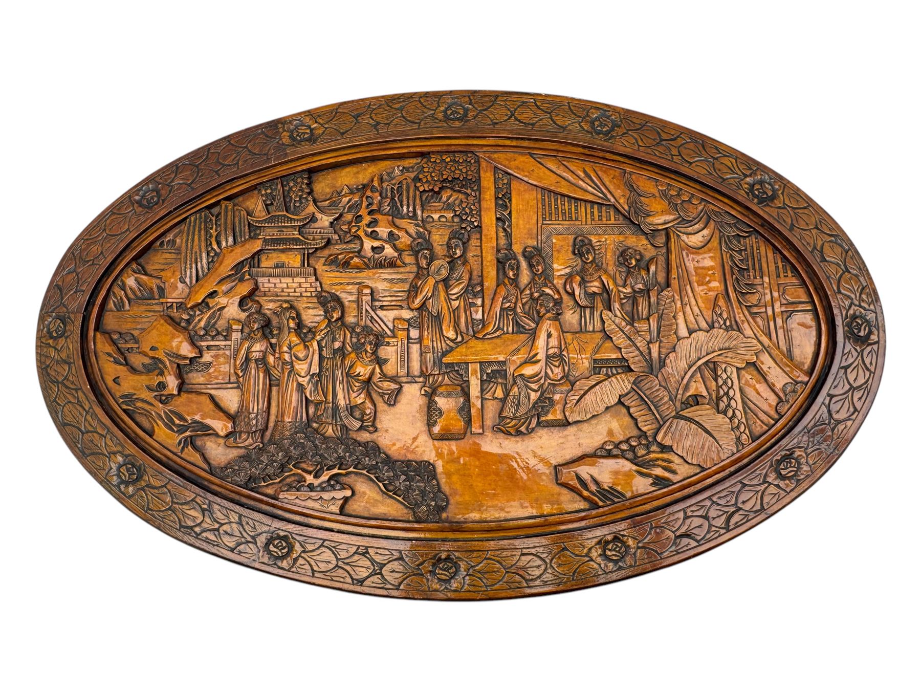 Early 20th century Chinese hardwood nesting coffee table, oval top carved with figures and traditional pagoda scenes with carved frieze, complete with six inset stools or side tables, raised on tapering supports with paw feet
