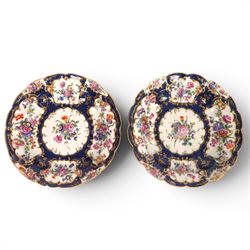 Pair of Worcester junket dishes, c1770, painted with panels of flowers on a blue scale gro...