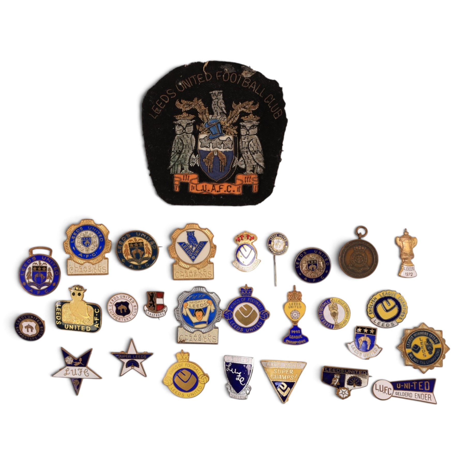 Collection of Leeds United enamel badges, including League Champions and League Winners examples, and a embroidered LUAFC patch
